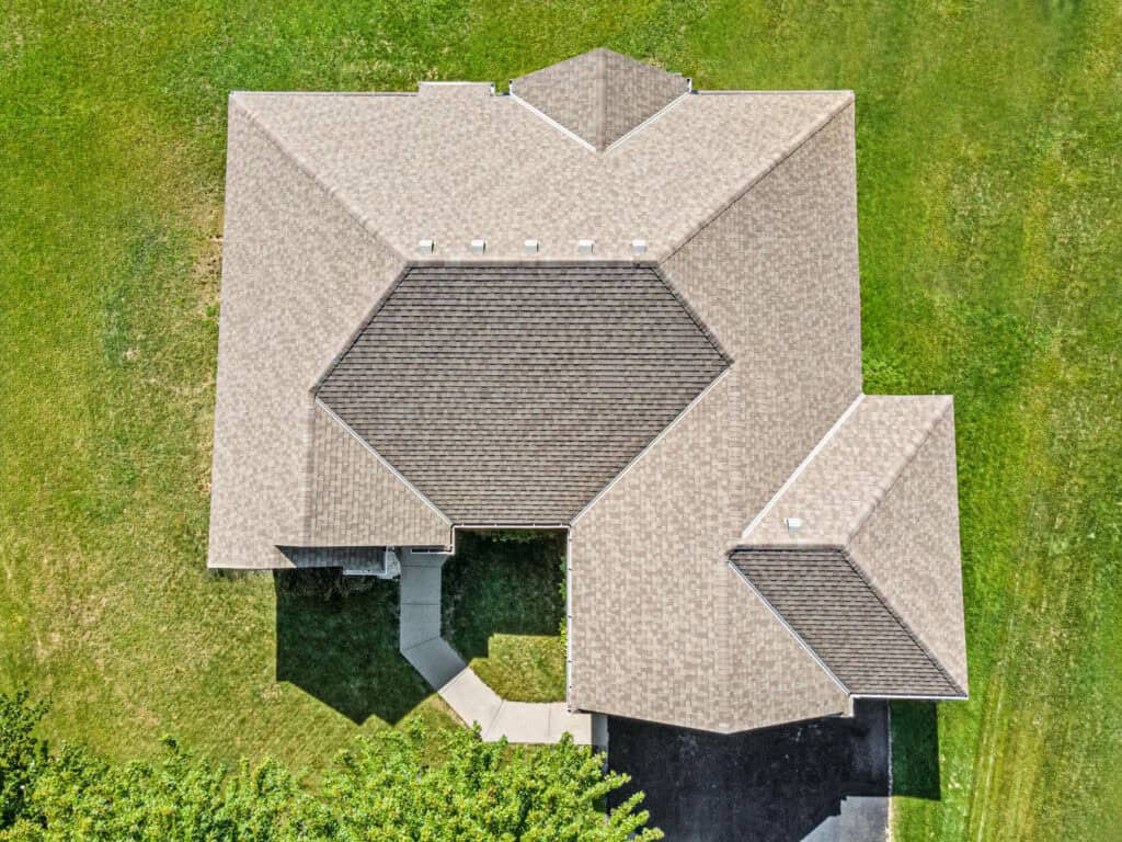 Aerial view of house roof and lawn.